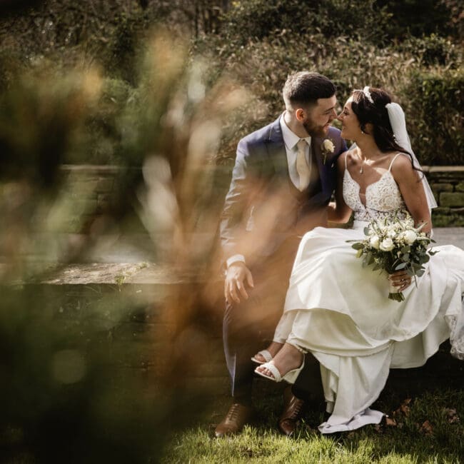bride and groom kissing at riverbarn