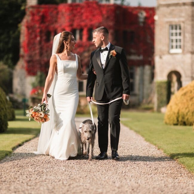 Ellie & sam – 2085 Bride & Groom and dog walking away from tissington hall | Yorkshire Wedding Photographer