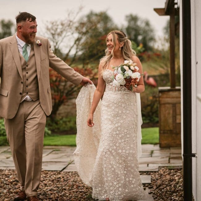 Faye & Tom – 1049 bride and groom around deighton lodge walking around