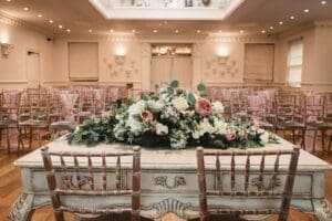 Civil ceremony room at Ashfield House wedding venue decorated with fresh flowers for a romantic wedding