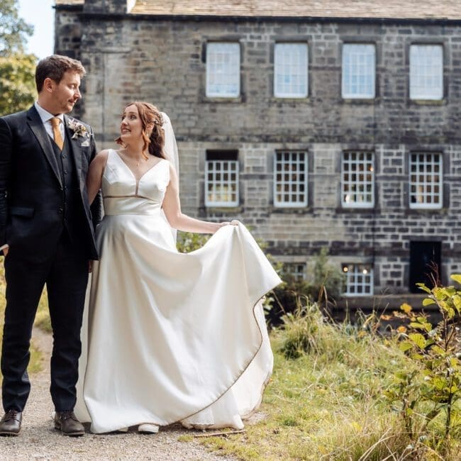bride and groom with gibson mill in the rear