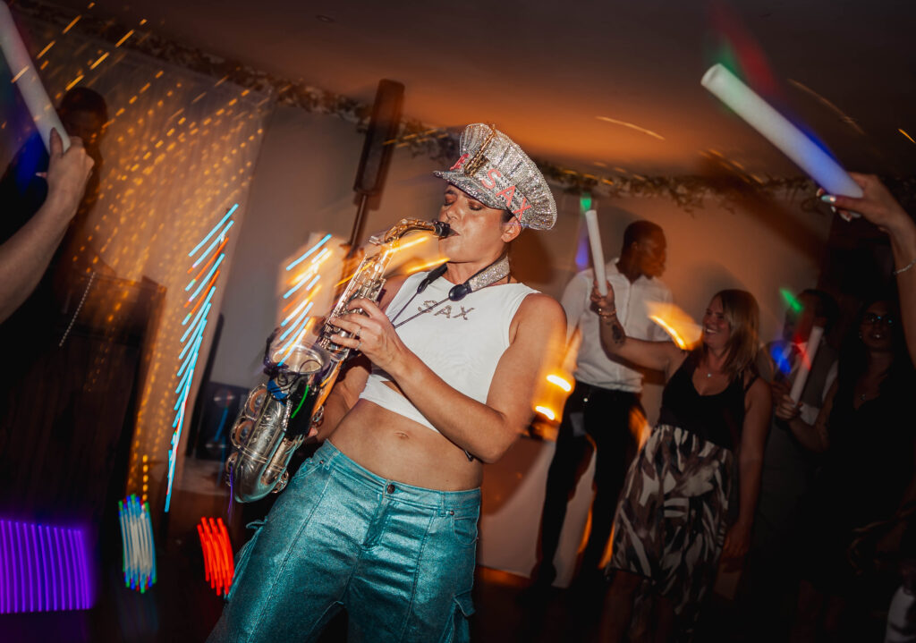 Ellie_Sax_Wedding (10) Ellie Sax playing Sax at a wedding entertaining a growd dressed in a ellie sax hat