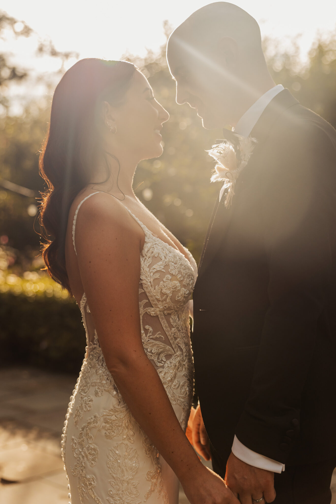 A bride and groom share an intimate, sun-drenched moment together during golden hour at their Yorkshire wedding.