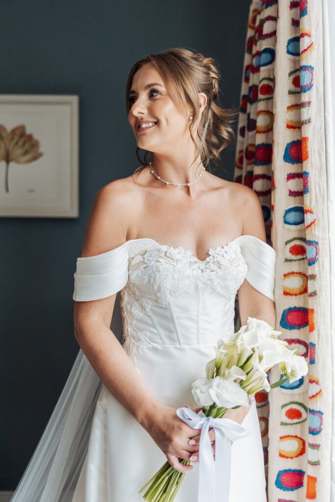 The bride in her off-shoulder gown before leaving for the ceremony at Wentbridge House Hotel.