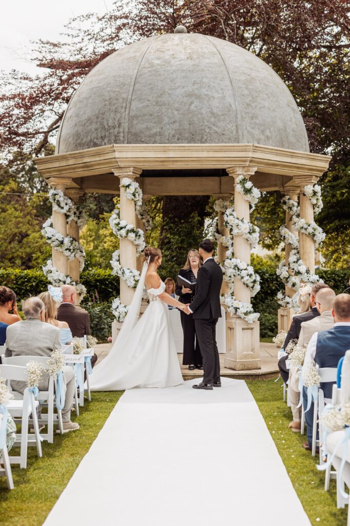 Vows beneath the garlanded stone pavilion at Wentbridge House Hotel near Pontefract.
