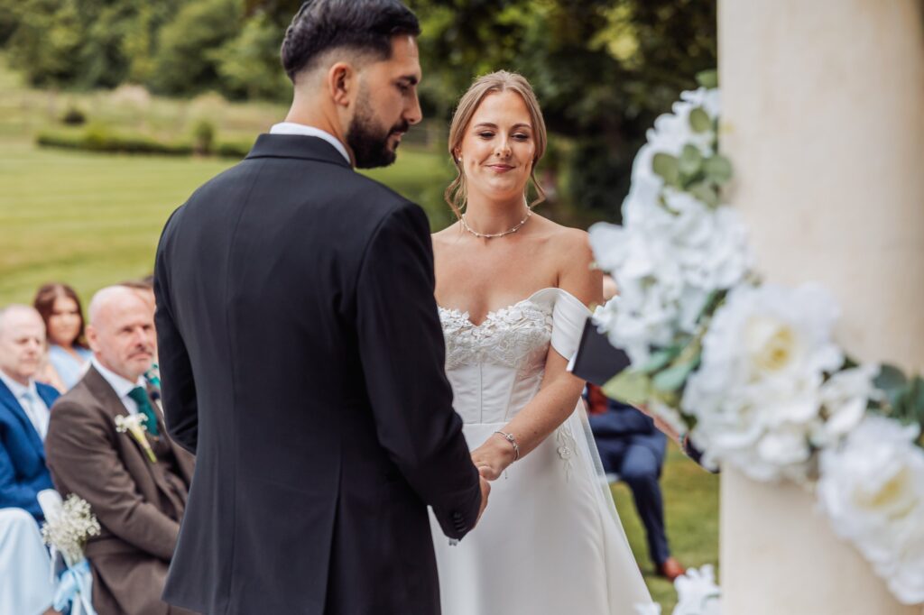 The exchange of rings during the outdoor ceremony at Wentbridge House Hotel.