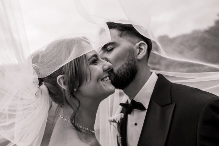 A black and white portrait beneath the veil on the lawns at Wentbridge House Hotel.