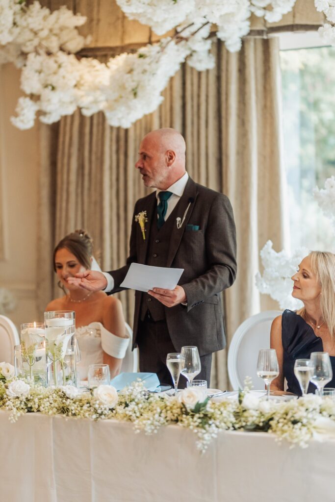 The father of the bride gives his speech beneath the blossom canopy at Wentbridge House Hotel.