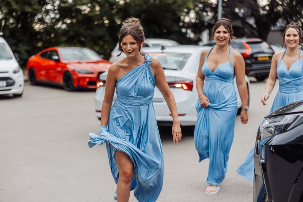 Bridesmaids in pale blue arriving ahead of the ceremony.