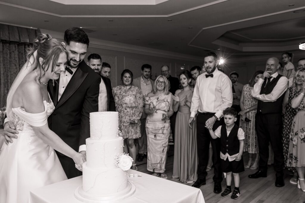 Cutting the wedding cake in the ballroom at Wentbridge House Hotel.