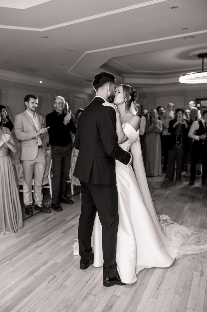 A kiss during the first dance, watched by family and friends at Wentbridge House Hotel.