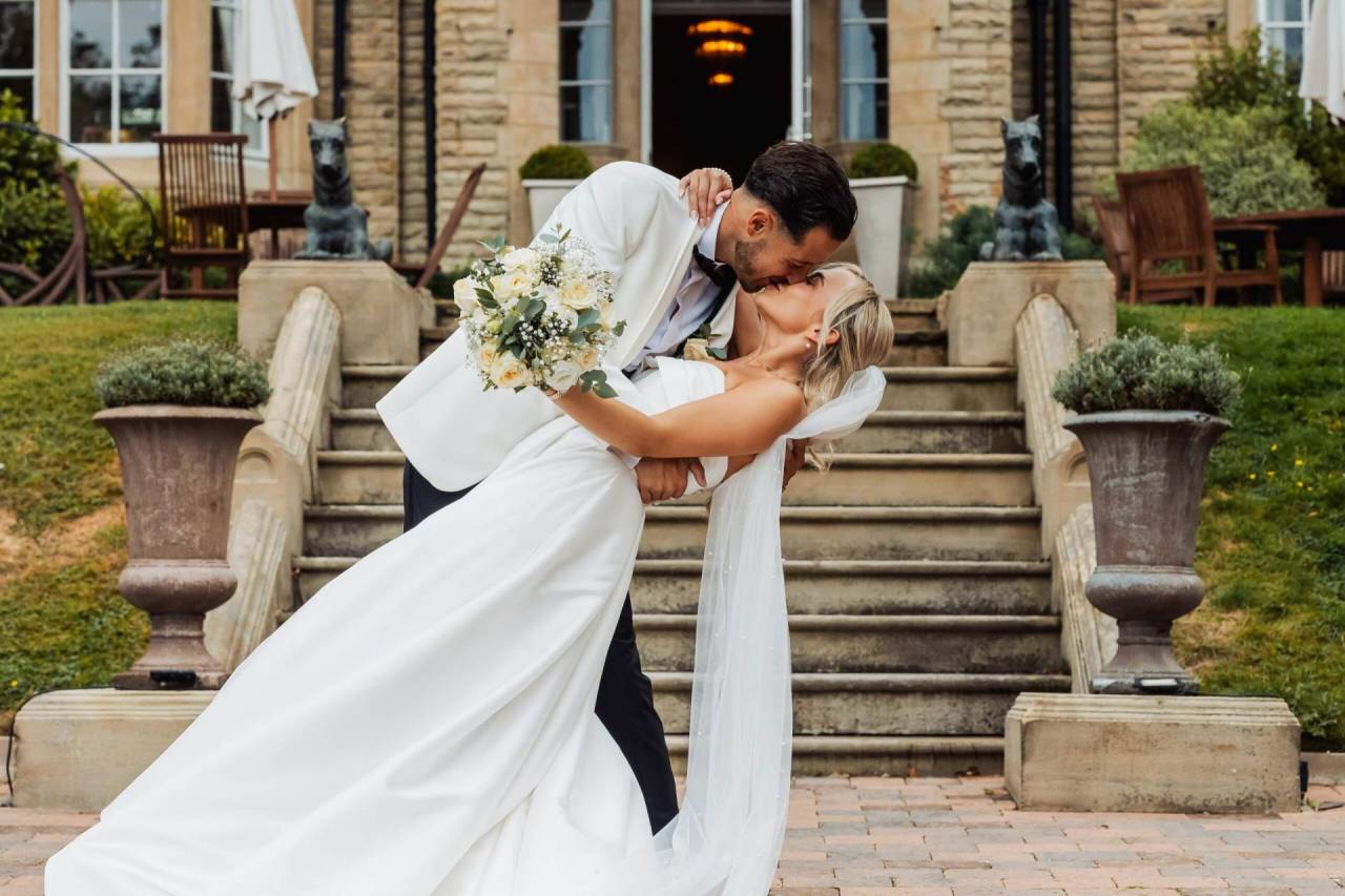 Adam and Katie sharing a dip kiss on their wedding day — Yorkshire wedding photography by Fabio Photography