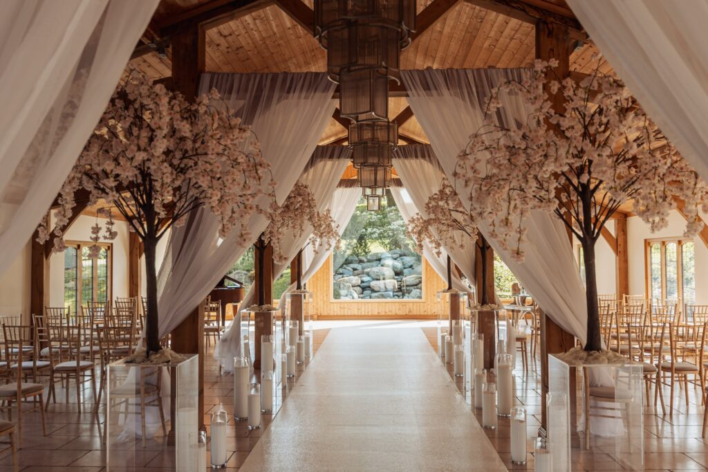 The beamed ceremony room at Colshaw Hall dressed with blossom arches before the ceremony