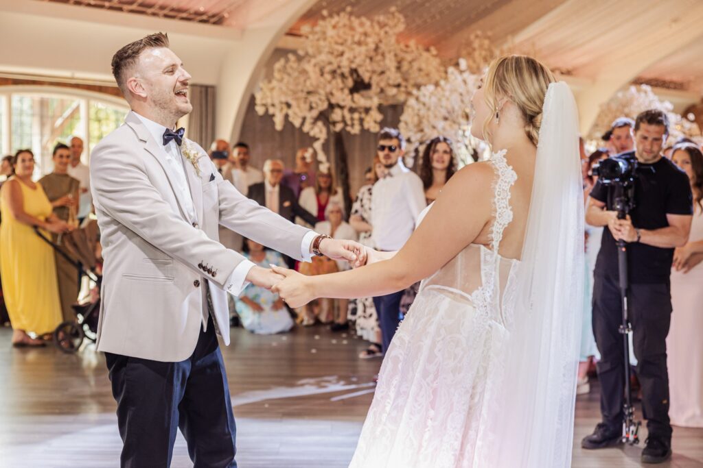 Jessica and Joshua during their first dance under the floral chandelier at Colshaw Hall