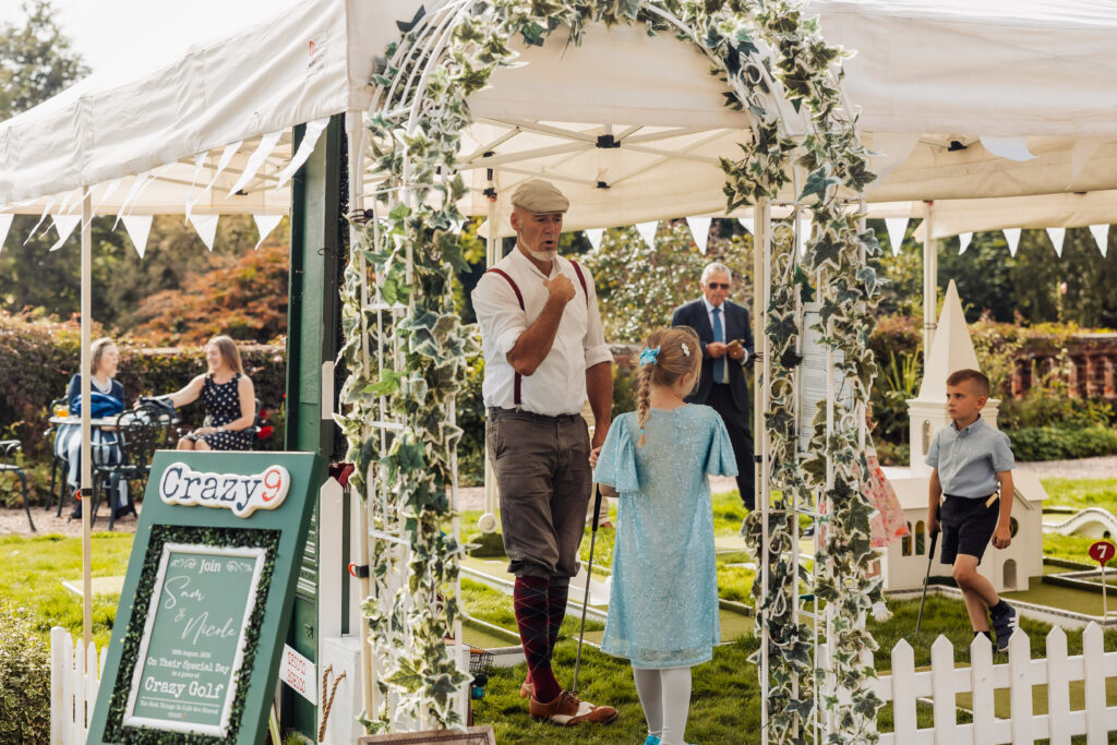 Wedding guests gathered in the reception space on the lawn at Hodsock Priory