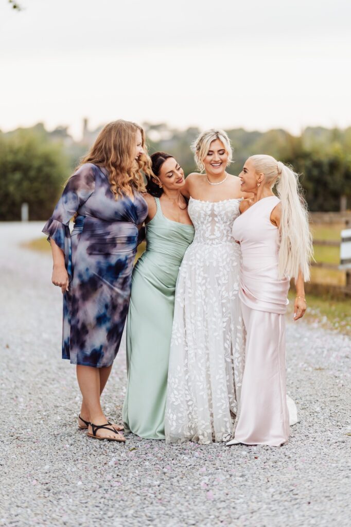 Bride hugging her bridesmaids outside Sedgewell Barn
