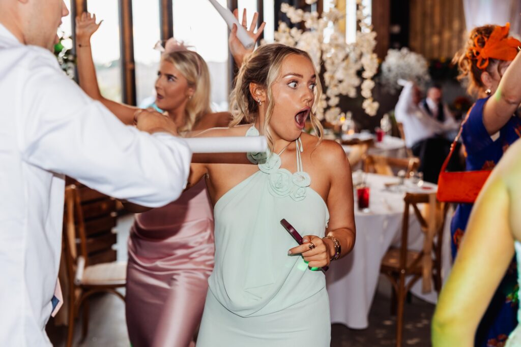 Guest pulling a surprised face at the table during the wedding breakfast