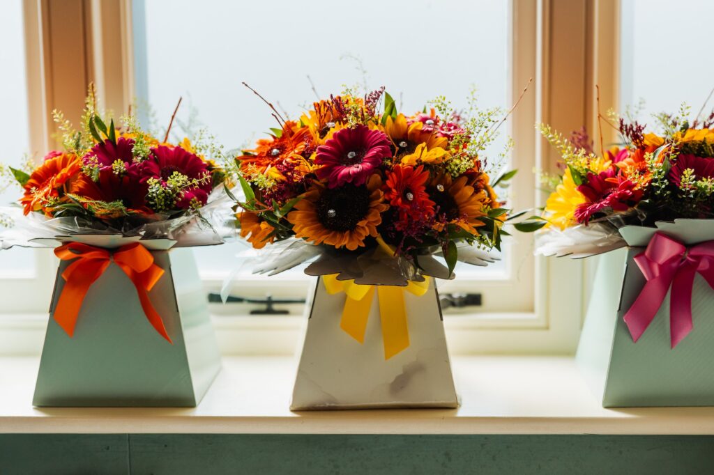 Sunflower and autumn flower arrangements on the windowsill in the barn at Sedgewell Barn