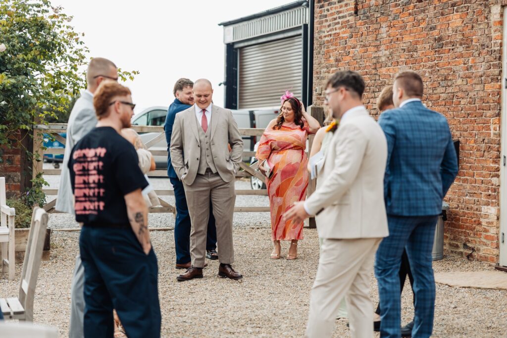 Wedding guests arriving outside the barn at Sedgewell Barn