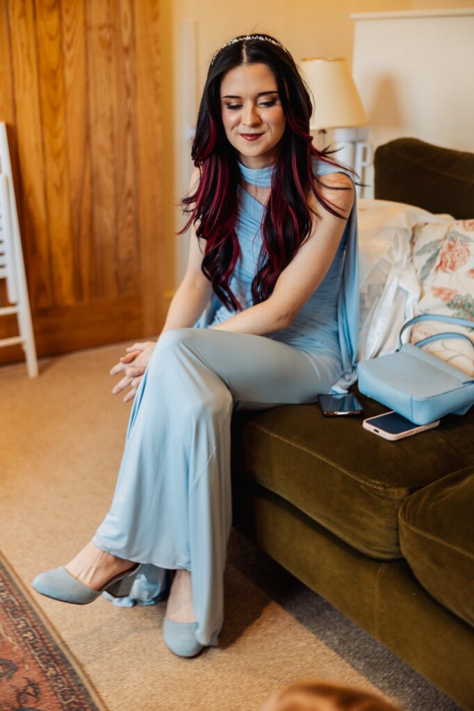 Bridesmaid relaxing on a sofa during the bridal preparations at Sedgewell Barn