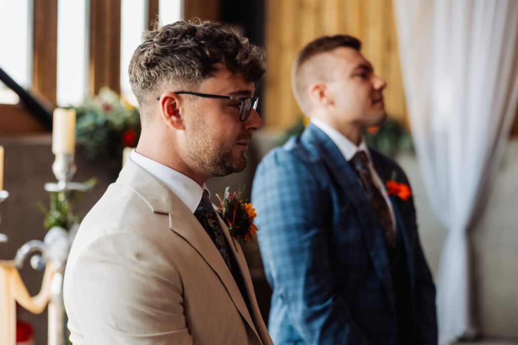 Groom and best man watching the bride arrive during the ceremony