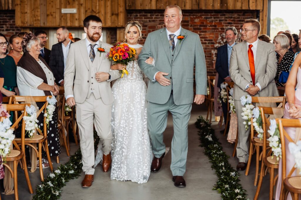 Bride walking down the aisle with her father at Sedgewell Barn