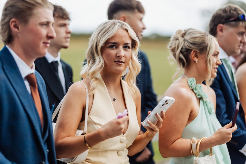 Wedding guests standing outside the barn at Sedgewell Barn