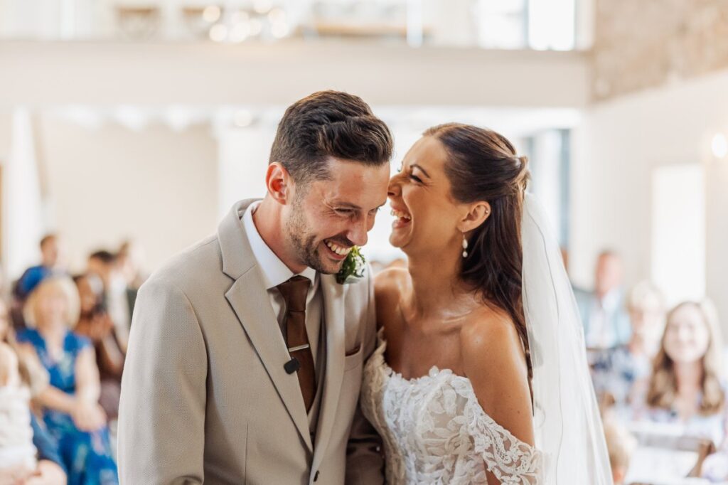 The couple laugh together moments after being married.