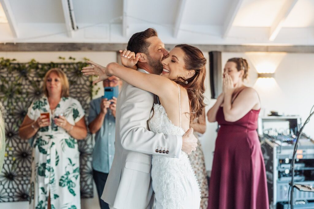 Bride and groom hold each other on the dance floor at the end of their wedding day near York.
